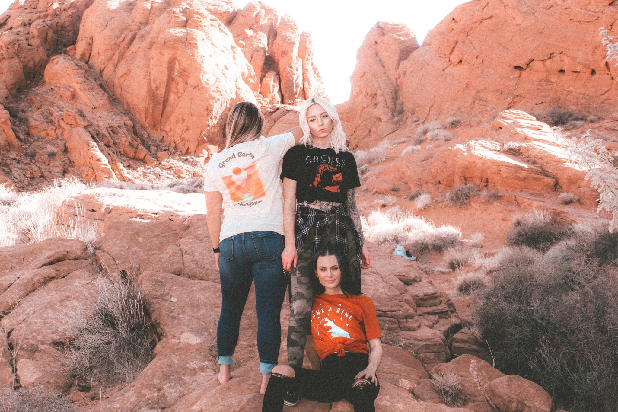 three women in a valley of red rocks
