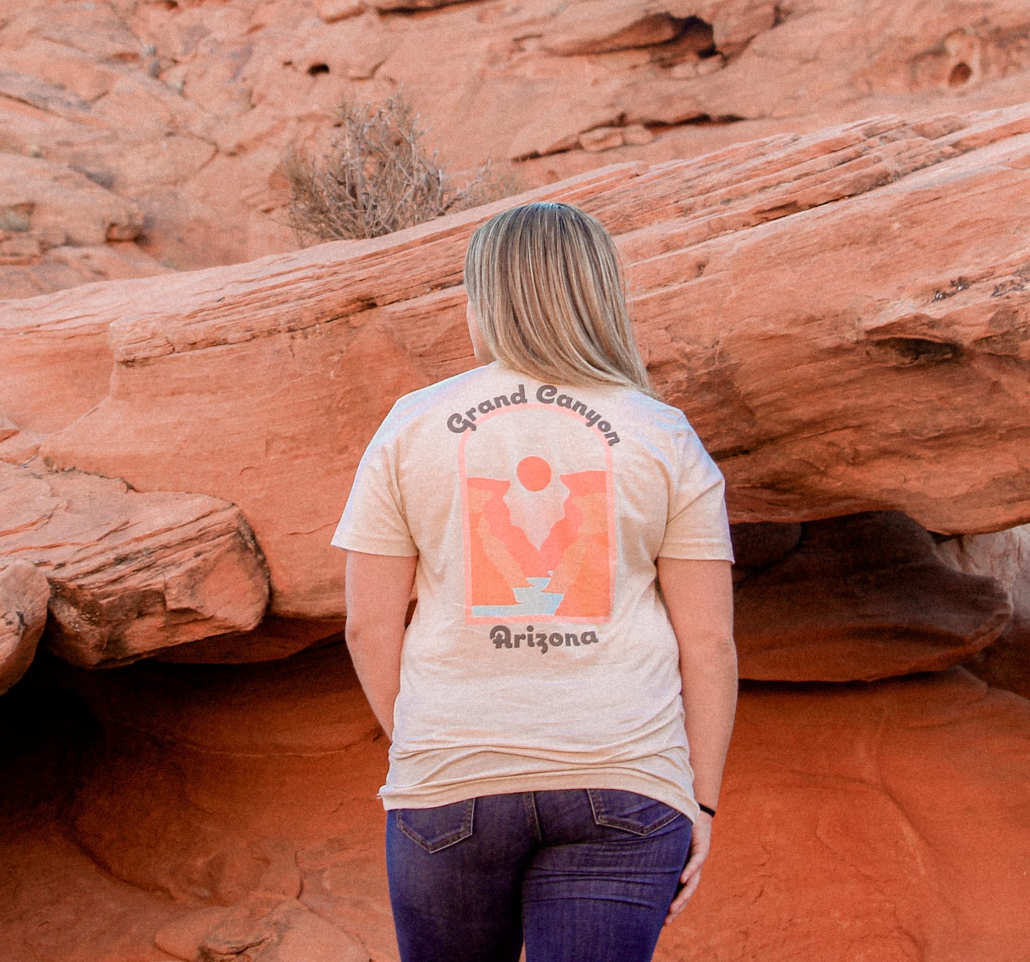 woman looking at a series of red rocks in a grand canyon t-shirt