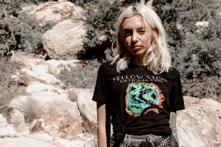 female in the mountains with a black yellowstone national park shirt