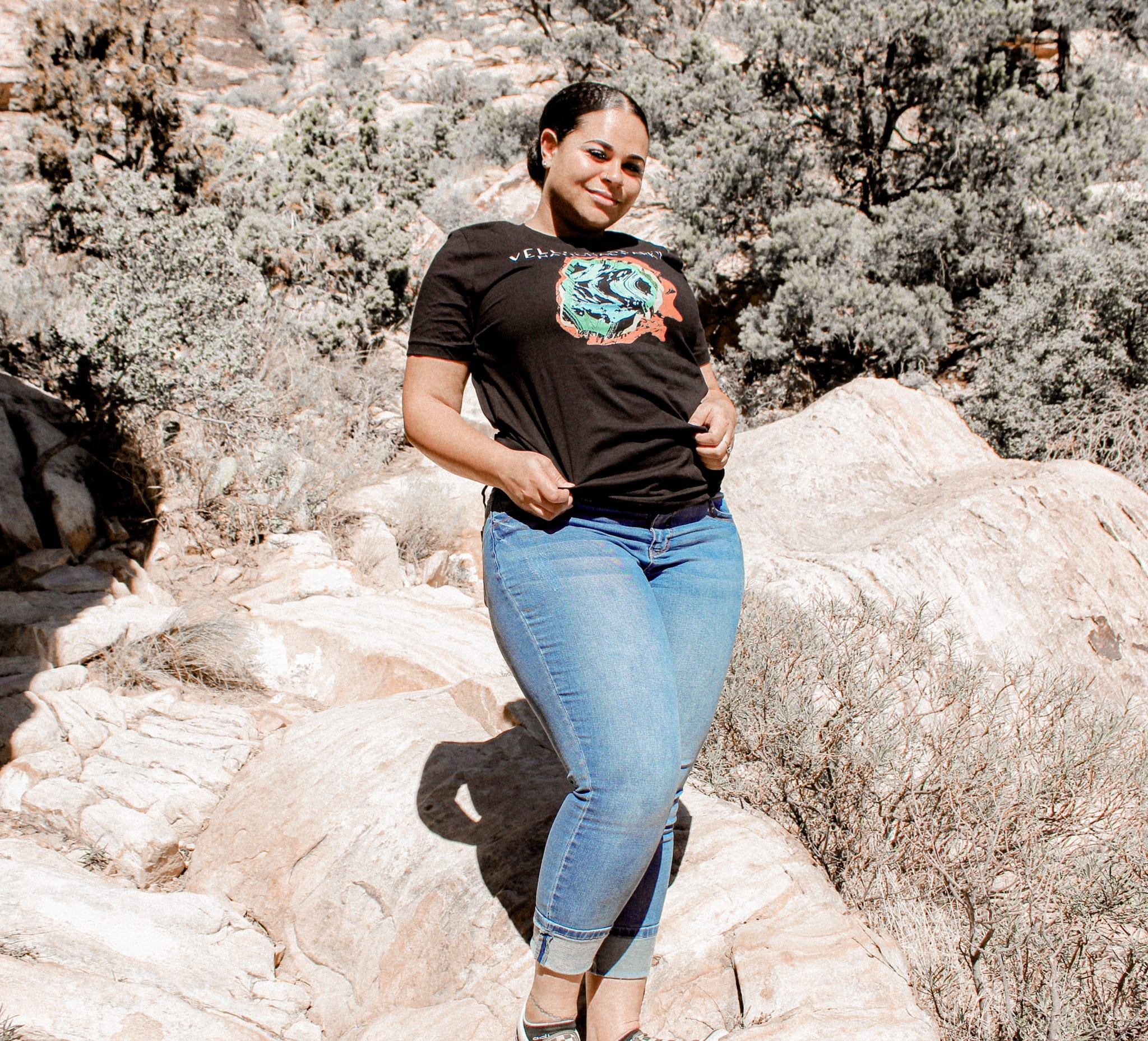 female in blue jeans and a black yellowstone national park t-shirt