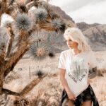 Girl standing next to joshua tree with saguaro national park shirt