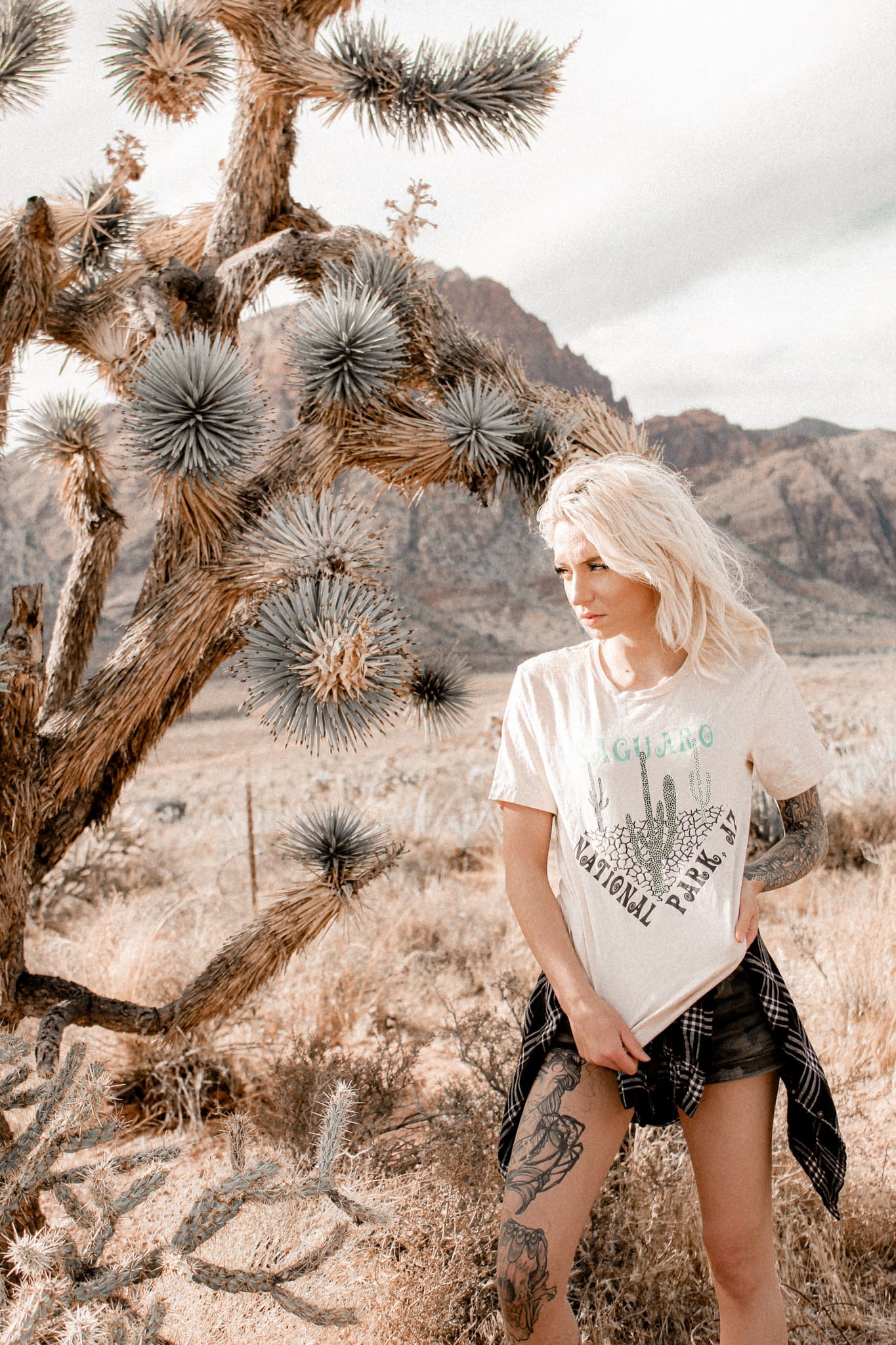Girl standing next to joshua tree with saguaro national park shirt